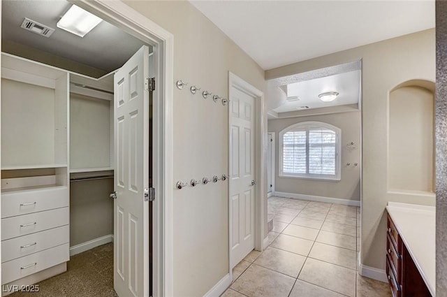 bathroom with vanity, visible vents, and baseboards