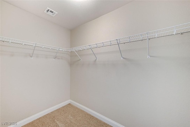 walk in closet with carpet floors and visible vents