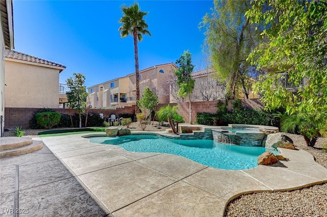 view of pool featuring a patio area, a fenced backyard, and a pool with connected hot tub