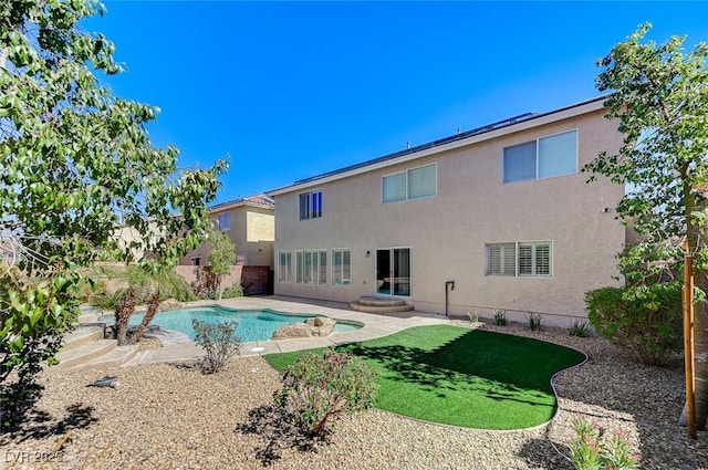 back of property featuring a patio, a fenced backyard, a fenced in pool, and stucco siding