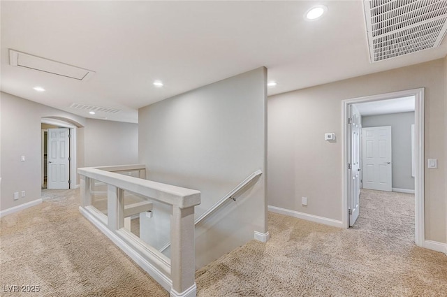 hall featuring visible vents, baseboards, carpet, an upstairs landing, and recessed lighting