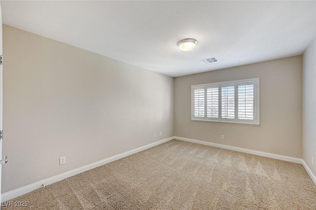 spare room with light carpet, baseboards, and visible vents