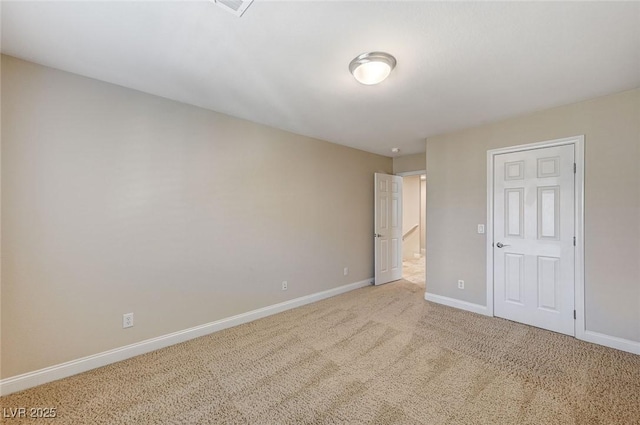 unfurnished bedroom with carpet flooring and baseboards