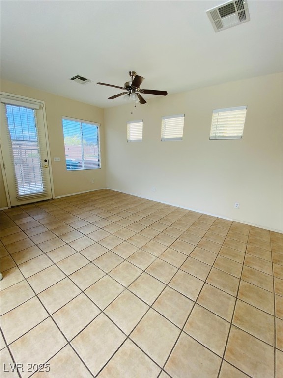 unfurnished room with ceiling fan and visible vents