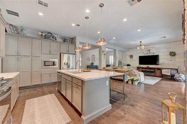 kitchen featuring appliances with stainless steel finishes, visible vents, and a sink