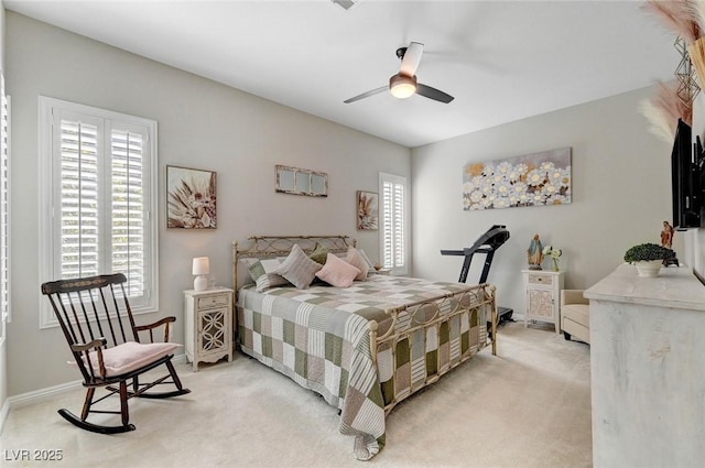 bedroom featuring ceiling fan, baseboards, and light colored carpet