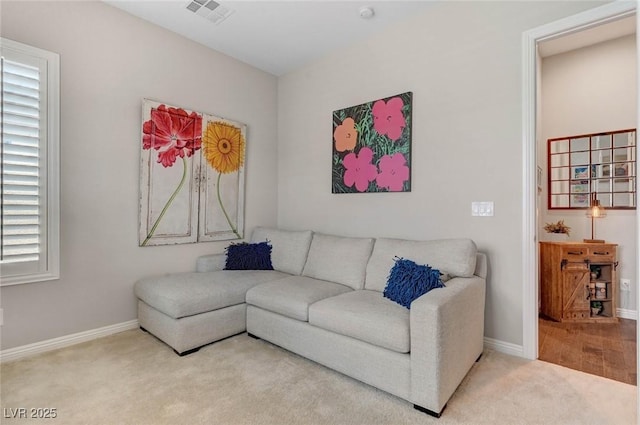 living room featuring baseboards, visible vents, and carpet flooring