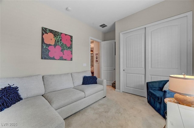 living area featuring light carpet and visible vents