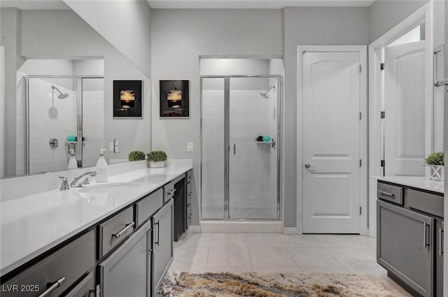 full bathroom with a stall shower, tile patterned flooring, and vanity