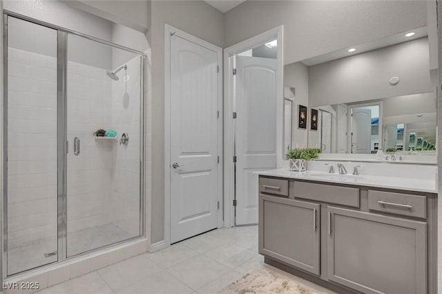 full bath with recessed lighting, a shower stall, vanity, and tile patterned floors