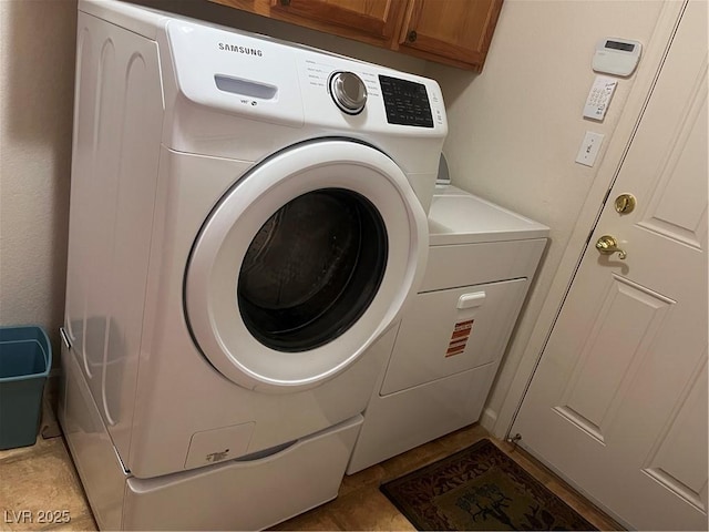 laundry room with washer and dryer and cabinet space