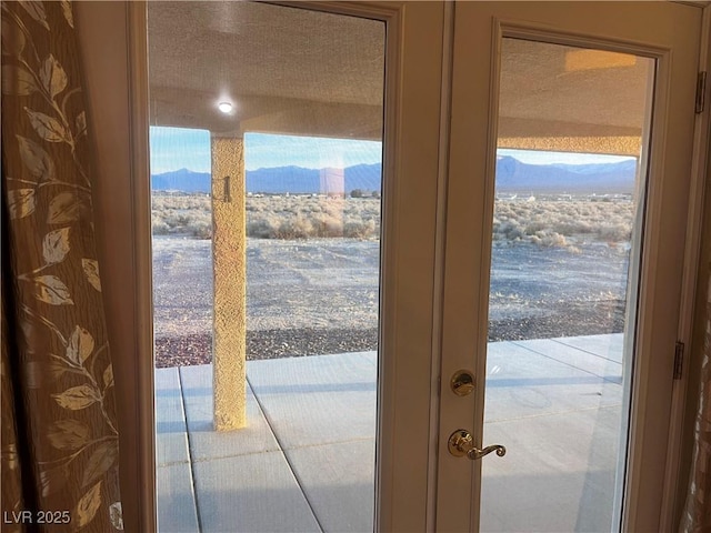 doorway to outside featuring a mountain view