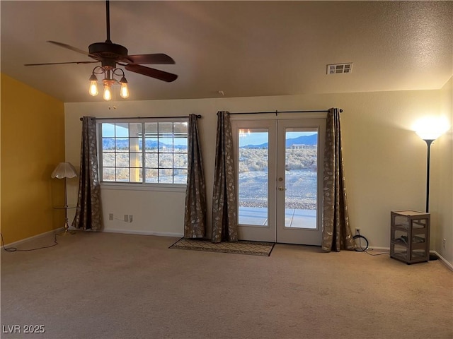 entryway featuring baseboards, visible vents, vaulted ceiling, carpet flooring, and french doors