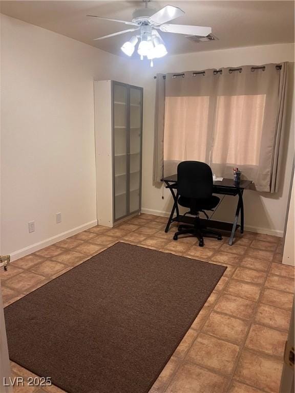 home office with visible vents, ceiling fan, and baseboards