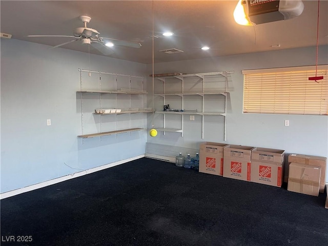 garage featuring ceiling fan and a garage door opener