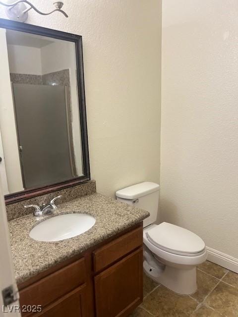 bathroom featuring toilet, tile patterned floors, and vanity