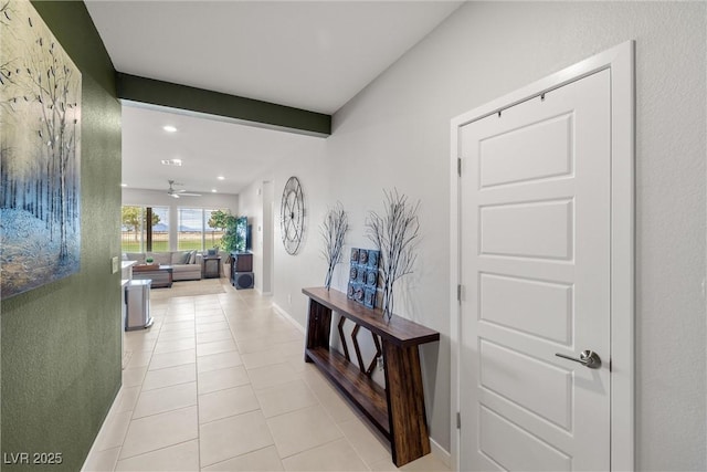 hall featuring light tile patterned floors, baseboards, beam ceiling, and recessed lighting