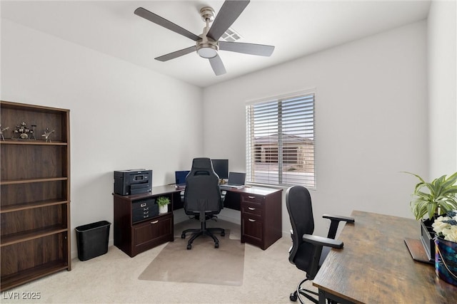 office featuring a ceiling fan and light colored carpet