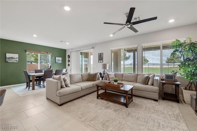 living room with visible vents, baseboards, ceiling fan, light tile patterned flooring, and recessed lighting