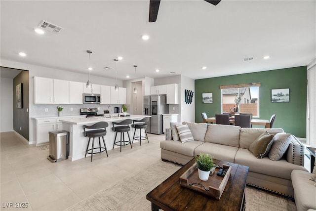 living area with visible vents and recessed lighting