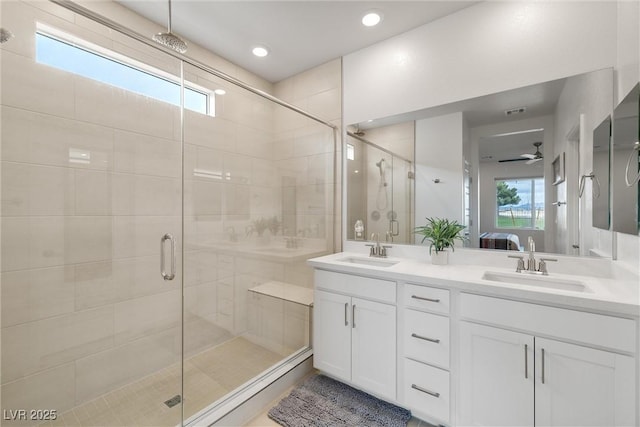 bathroom featuring a stall shower, a sink, and ensuite bathroom