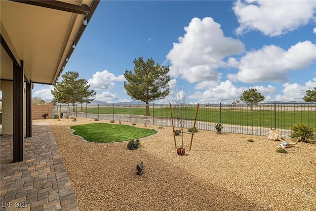 view of yard featuring a rural view and fence