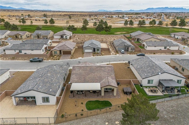 drone / aerial view featuring a residential view and a mountain view