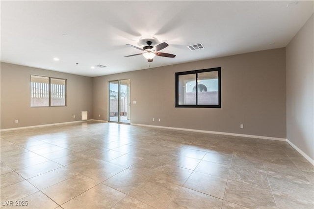 empty room with visible vents, ceiling fan, baseboards, and light tile patterned floors