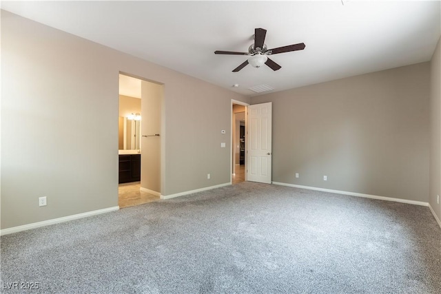 unfurnished bedroom with visible vents, light carpet, connected bathroom, ceiling fan, and baseboards