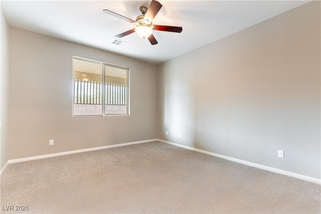 spare room with ceiling fan, baseboards, and carpet flooring