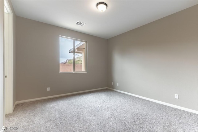 carpeted empty room featuring visible vents and baseboards