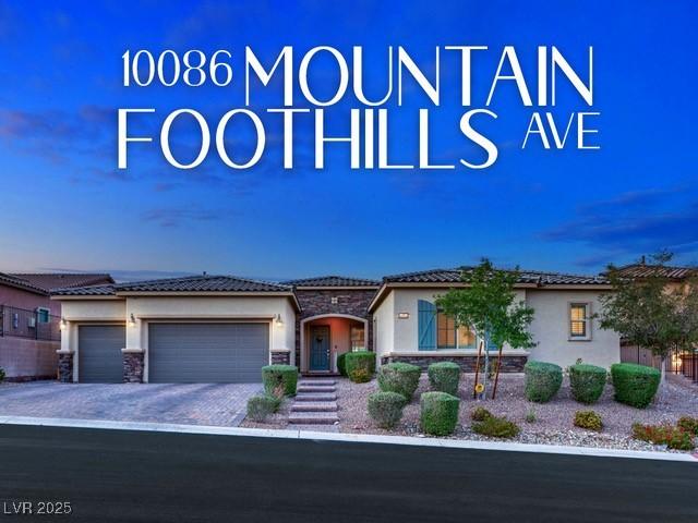 view of front of house featuring driveway, stone siding, a garage, and stucco siding