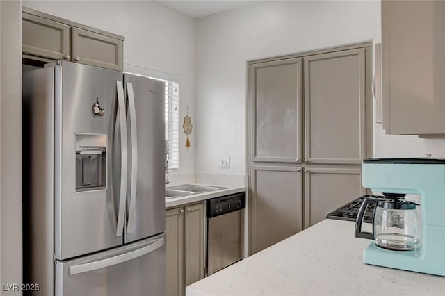 kitchen featuring stainless steel appliances and gray cabinetry