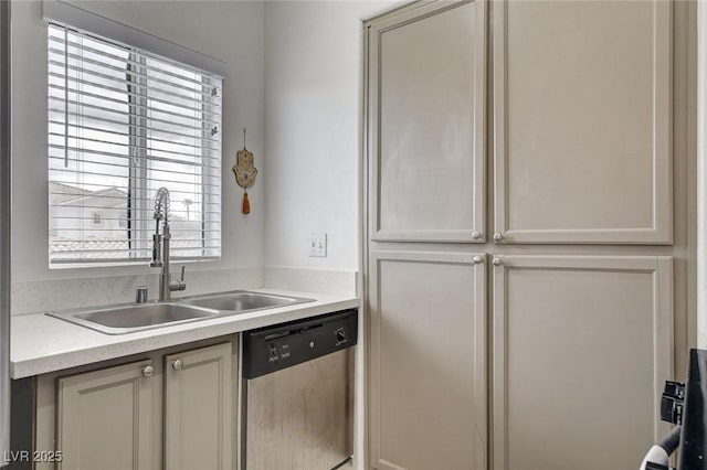 kitchen with light countertops, stainless steel dishwasher, and a sink