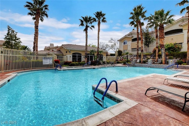 pool featuring fence and a patio