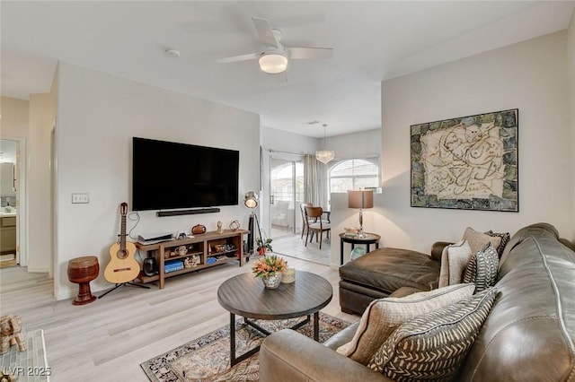 living area featuring ceiling fan and light wood finished floors