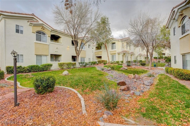 view of property's community with a residential view and a yard