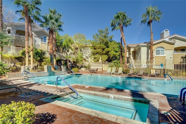 community pool featuring a patio area and fence