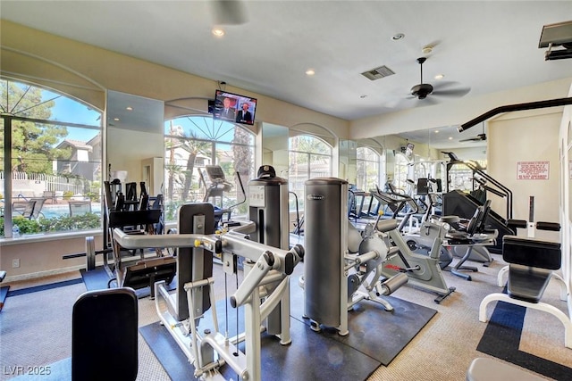 gym with a ceiling fan, recessed lighting, visible vents, and a healthy amount of sunlight