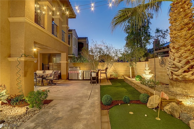 exterior space with a patio, an outdoor kitchen, and fence