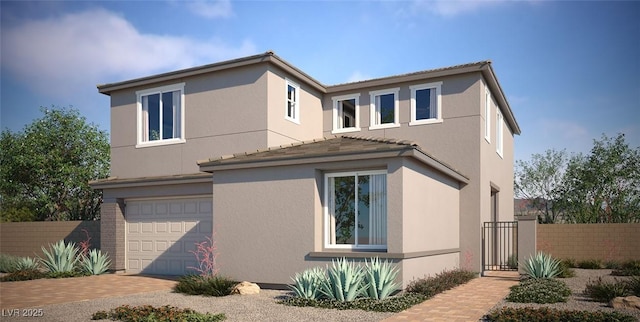 view of home's exterior featuring an attached garage, fence, decorative driveway, and stucco siding