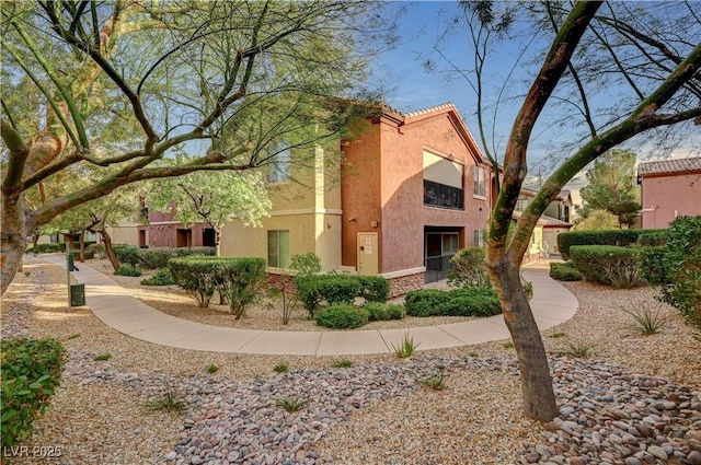 view of side of home with stucco siding