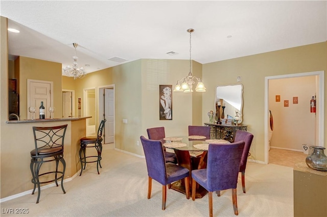 dining area with light colored carpet, visible vents, baseboards, and an inviting chandelier