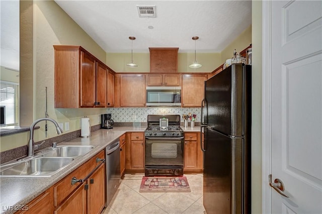 kitchen with light tile patterned floors, tasteful backsplash, visible vents, black appliances, and a sink