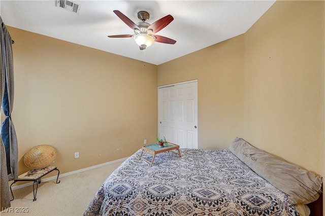 carpeted bedroom with a ceiling fan, a closet, visible vents, and baseboards