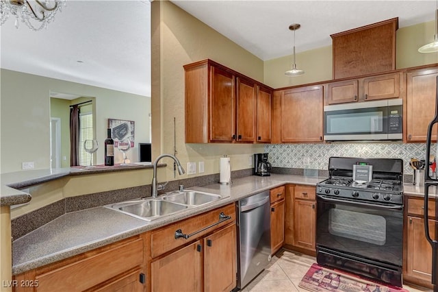 kitchen featuring light tile patterned floors, tasteful backsplash, appliances with stainless steel finishes, brown cabinetry, and a sink