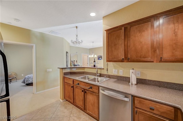 kitchen featuring stainless steel dishwasher, light tile patterned flooring, a sink, and brown cabinets