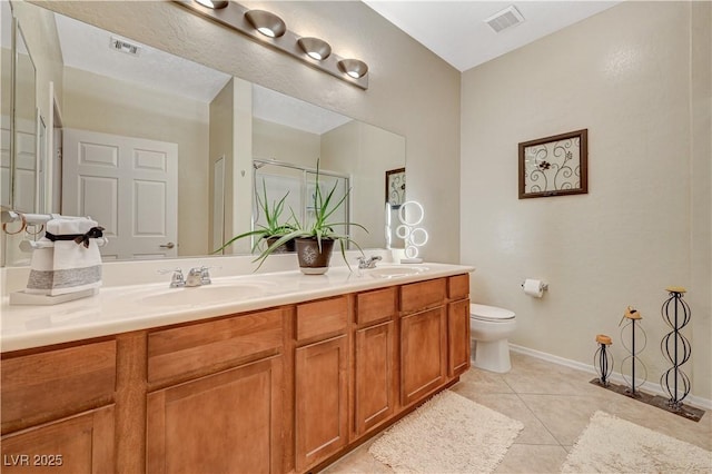 bathroom with tile patterned flooring, visible vents, and a sink