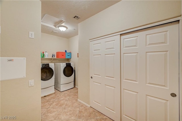 clothes washing area with visible vents, attic access, light tile patterned flooring, a textured ceiling, and independent washer and dryer