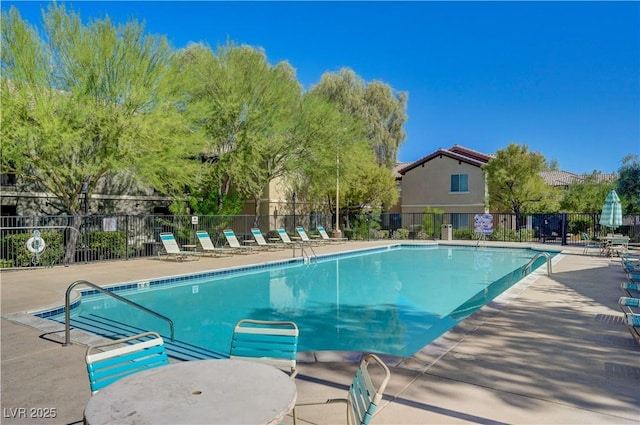 pool featuring fence and a patio